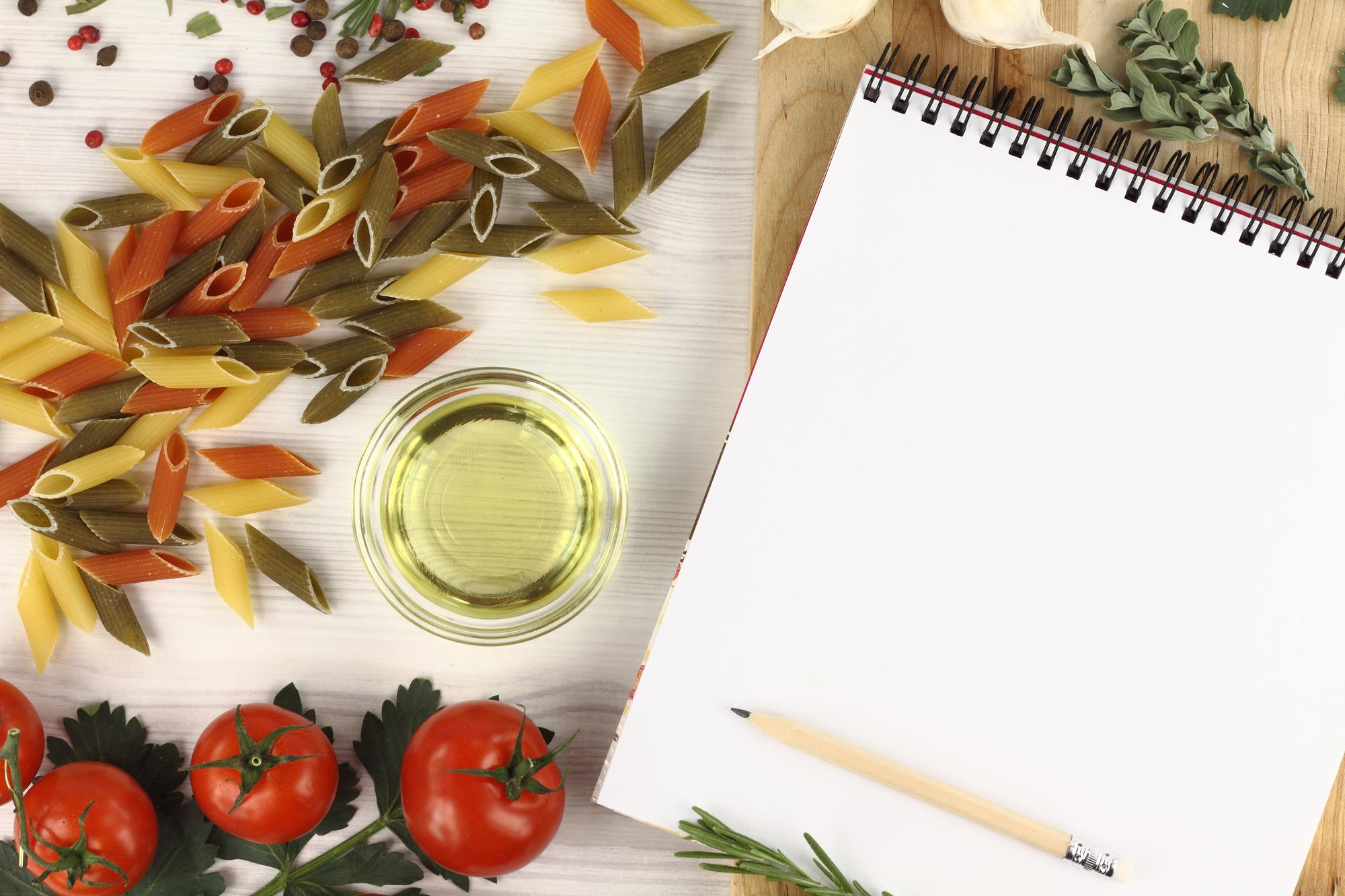 Notebook with meal plan and herbs